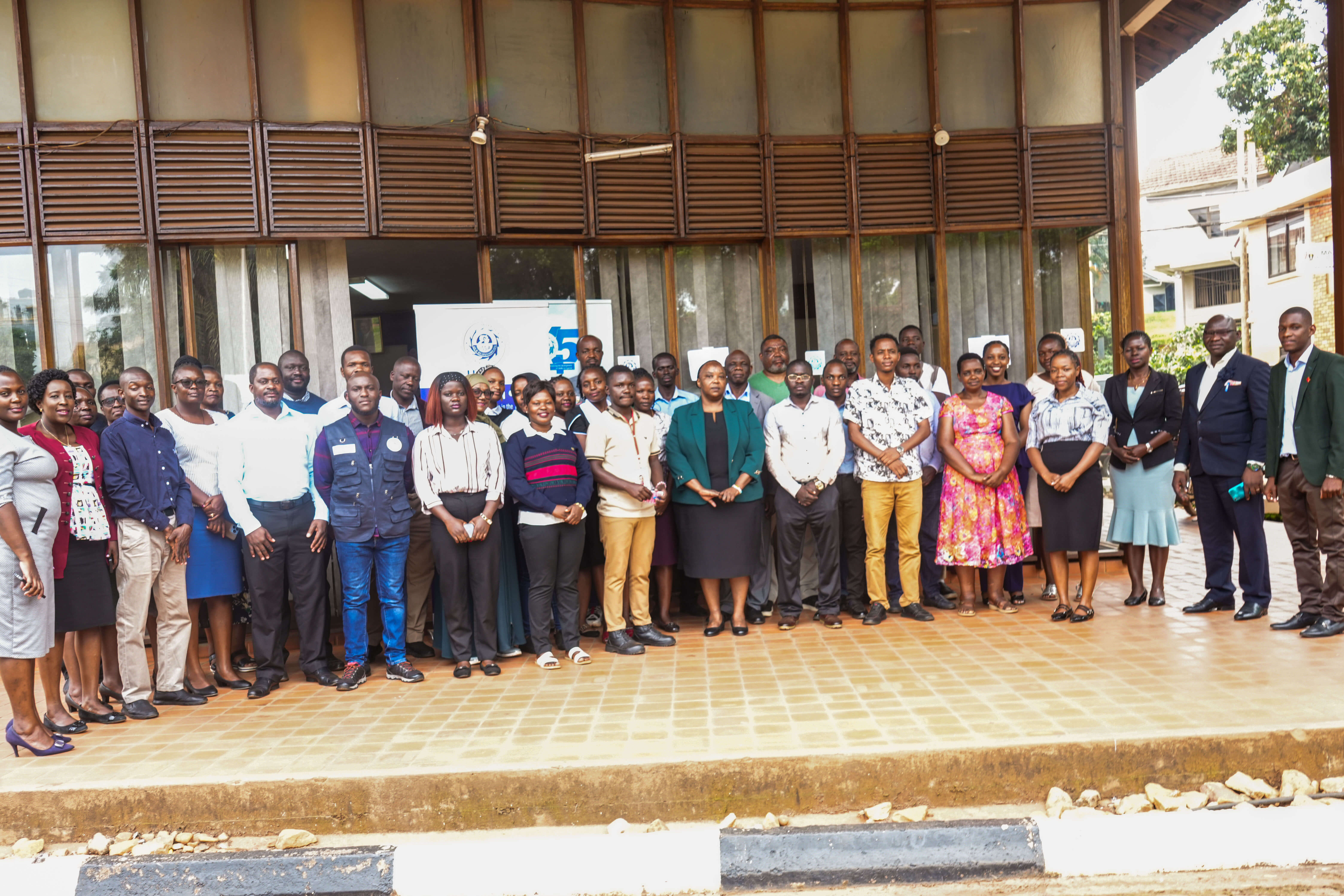 Participants who attended the workshop pose for a group photo with the Secretary General of Uganda Small Scale Industries Association