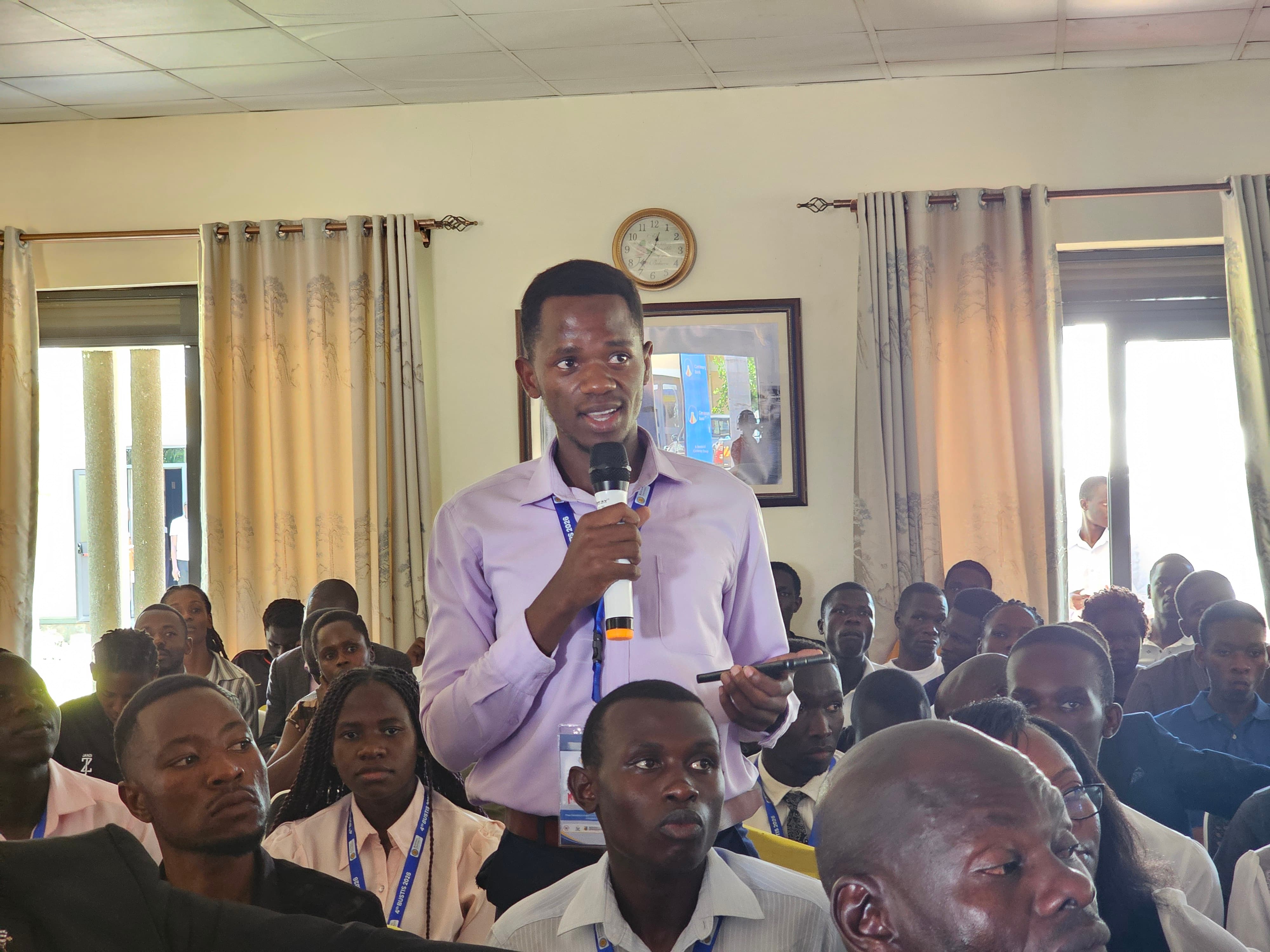 A student raises a question during an interactive discussion session at the 4th Busitema University Annual Science, Technology and Innovation Symposium.