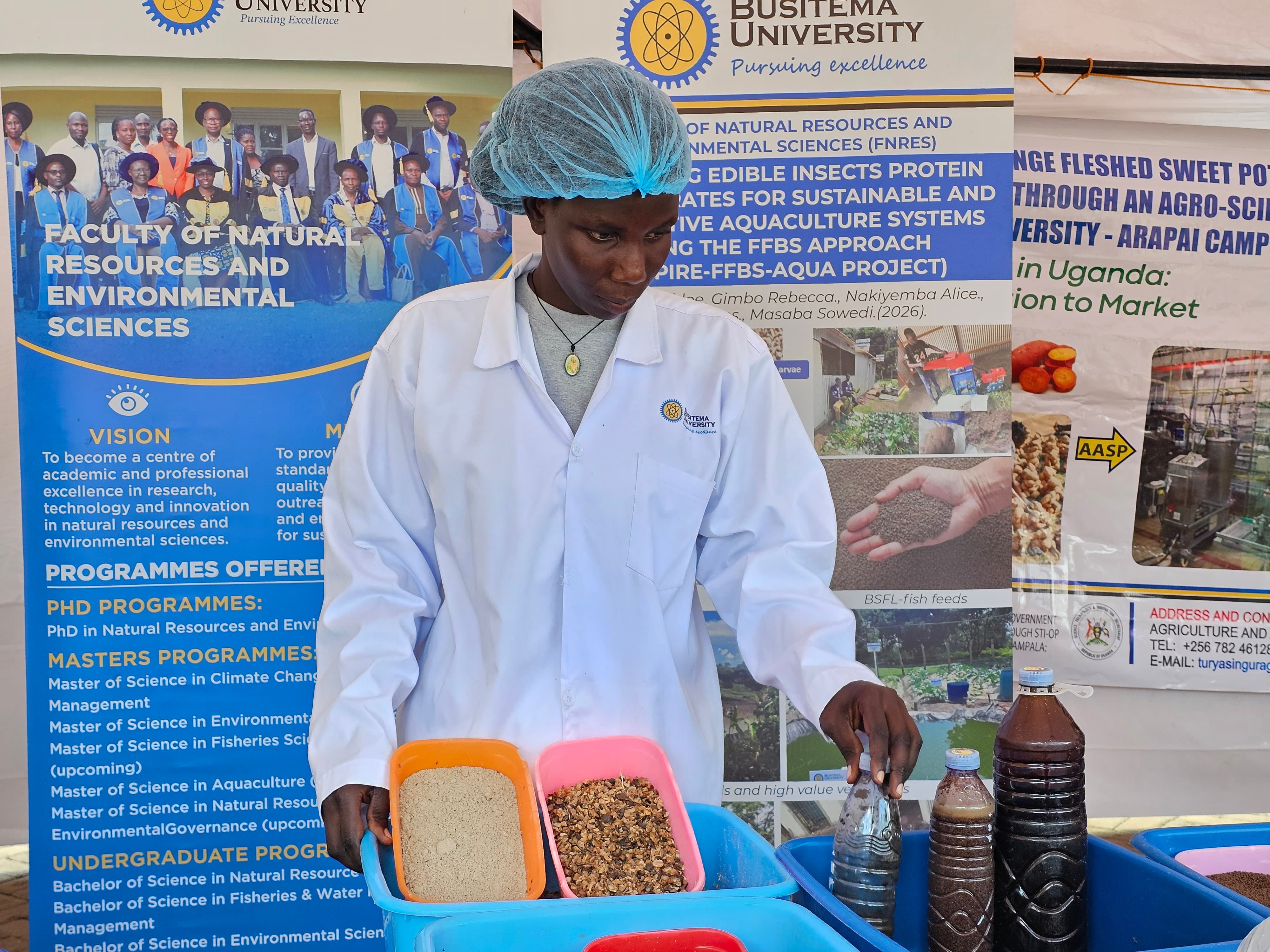 A member of the INSPIRE-FFBS-AQUA project team displays insect-based aquaculture feed ingredients during the innovation exhibition at the 4th Busitema University Annual Science, Technology and Innovation Symposium.
