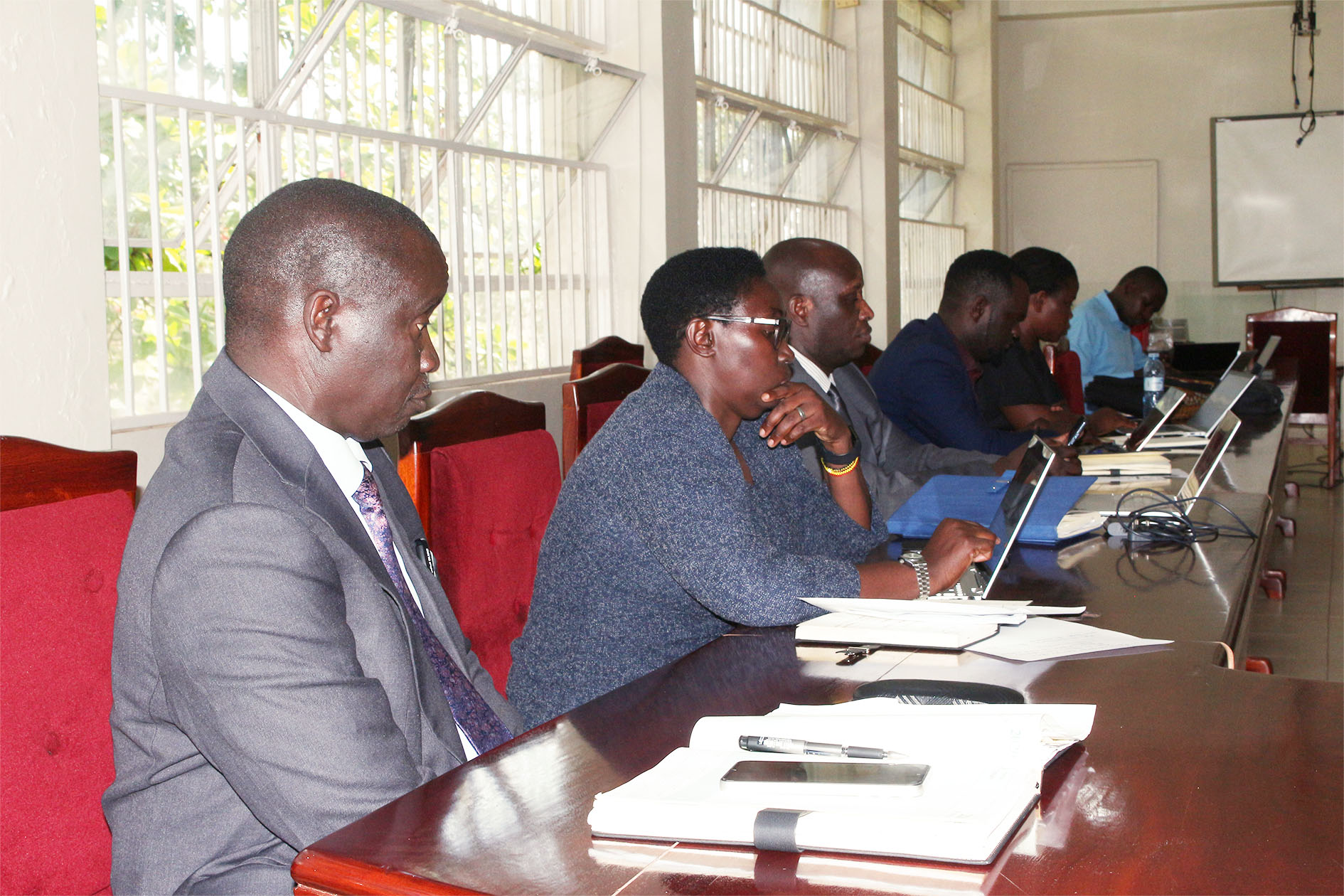 Vice Chancellor Prof. Paul Waako and members of Top Management follow presentations by project leaders during the review meeting.