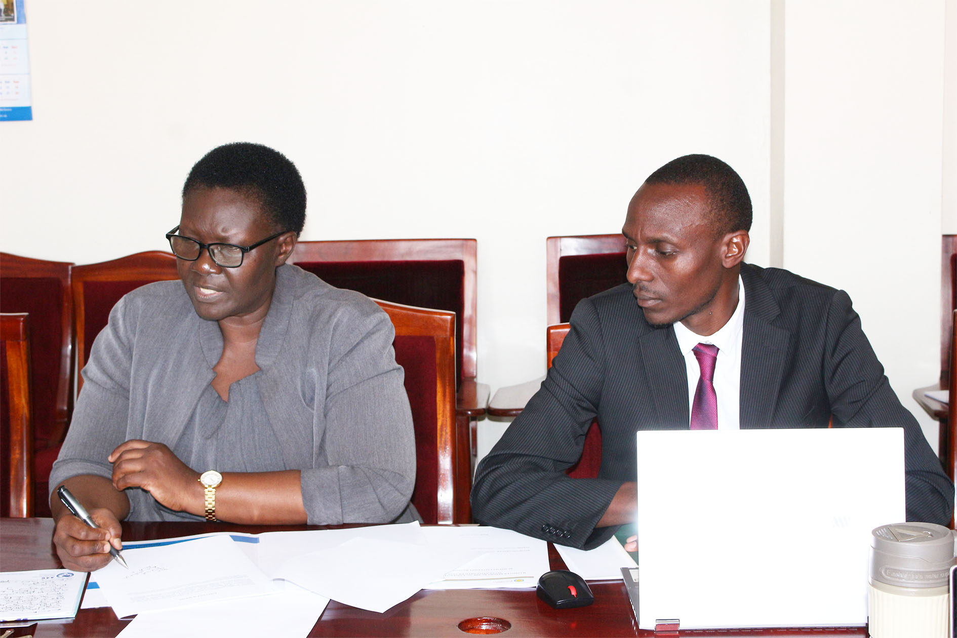 L–R: Outgoing Acting University Secretary Ms. Rachel Wandeka and newly appointed University Secretary Dr. Gregory Tweheyo.