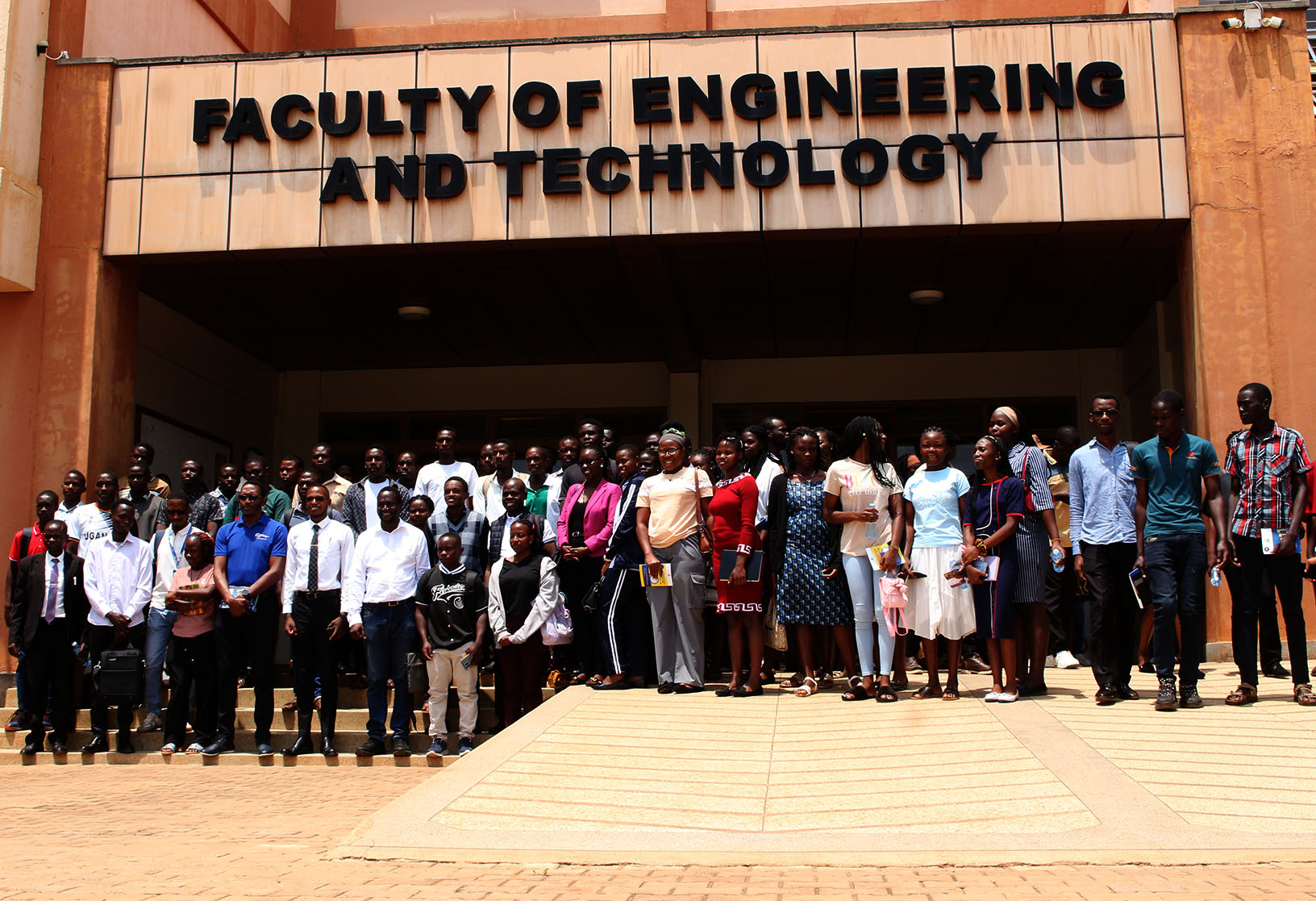 First-year students pose for a group photo with representatives of the Ultimate University Quiz.