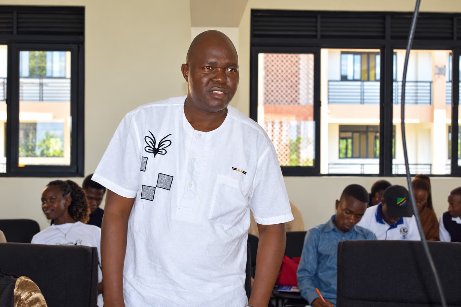 Caption: Mr. Mugabi Ivan Ronald, Deputy Academic Registrar responsible for Admissions, addresses international students on registration procedures, lecture attendance and examination requirements during the orientation at Namasagali Campus.